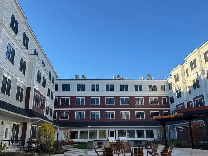 Four-story condominium buildings around a landscaped courtyard