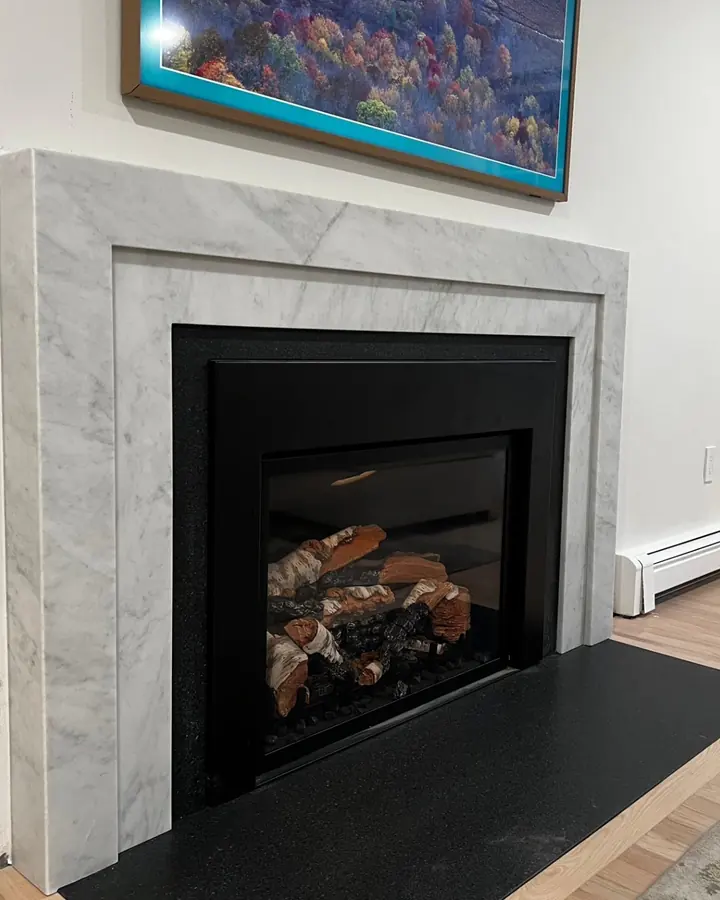 Marble surround and hearth around a black fireplace insert