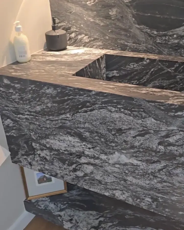 Dark granite vanity top with an undermount sink